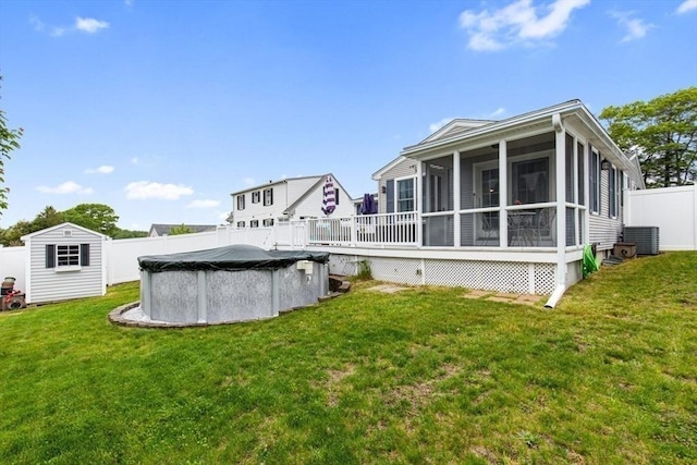back of house featuring a sunroom and central AC unit