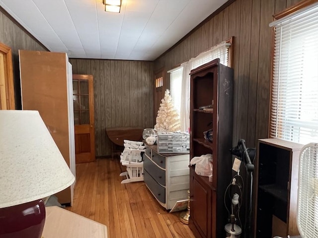 miscellaneous room featuring wooden walls and light hardwood / wood-style flooring