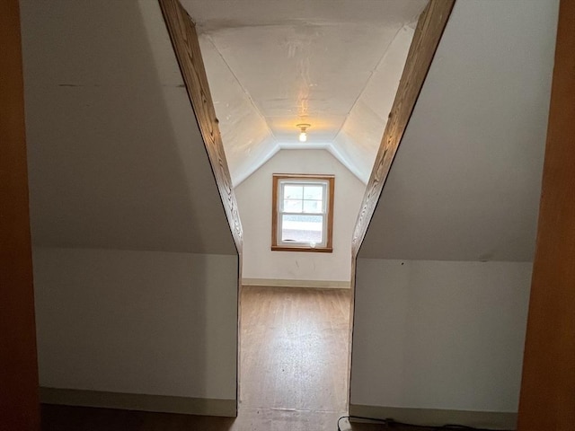 bonus room featuring vaulted ceiling and wood-type flooring