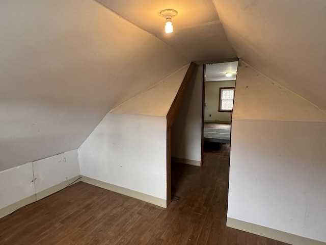 bonus room featuring dark wood-type flooring and lofted ceiling