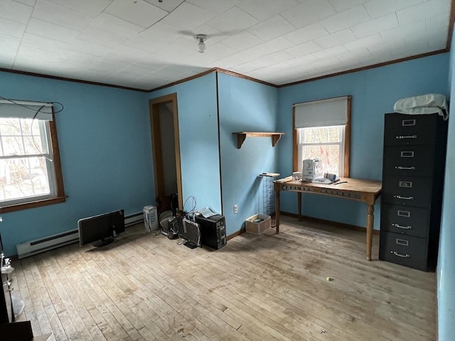 interior space with baseboard heating, ornamental molding, and wood-type flooring