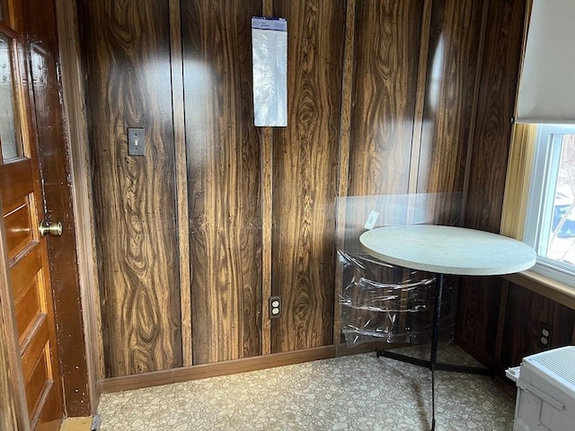 dining room featuring wood walls