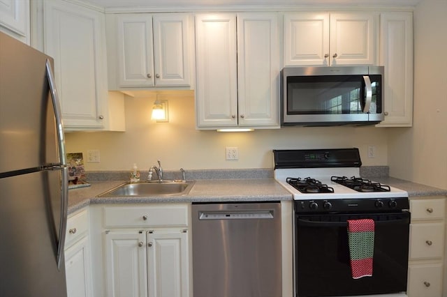 17 Bayberry Cir Unit 17, Millis, MA 02054 - kitchen with stainless steel appliances, a sink, white cabinetry, and light countertops