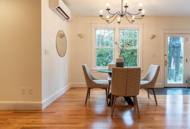 88 Round Hill Rd Unit 4, Northampton, MA 01060 - dining room featuring a chandelier, a wall mounted AC, light wood-style flooring, and baseboards