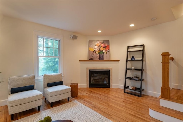 88 Round Hill Rd Unit 4, Northampton, MA 01060 - living area with light wood-style flooring, a tiled fireplace, recessed lighting, and baseboards