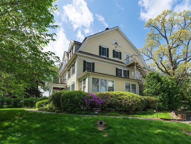 88 Round Hill Rd Unit 4, Northampton, MA 01060 - view of property exterior featuring a balcony, a yard, and a gambrel roof