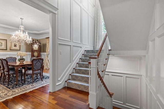 236 Grove St, Wellesley, MA 02482 - stairs with a decorative wall, a chandelier, wood finished floors, and ornamental molding