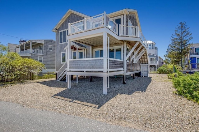 view of front of home featuring fence and a balcony