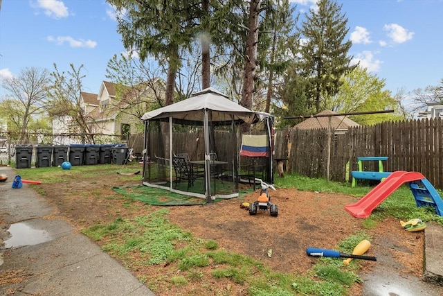 view of play area with a gazebo and fence private yard