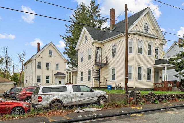 view of front of house featuring a chimney