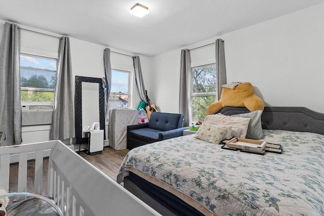 bedroom with wood finished floors and cooling unit