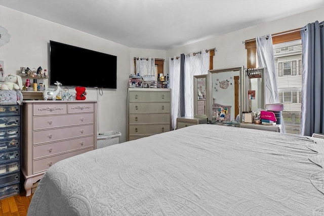 bedroom featuring multiple windows and wood finished floors