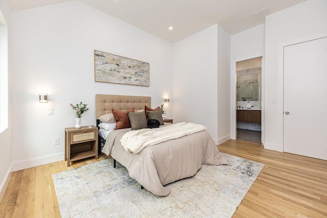 95 Griswold St Unit 95, Cambridge, MA 02139 - bedroom featuring wood finished floors, baseboards, connected bathroom, and recessed lighting