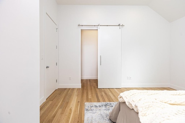 95 Griswold St Unit 95, Cambridge, MA 02139 - bedroom featuring light wood-style floors, baseboards, and vaulted ceiling