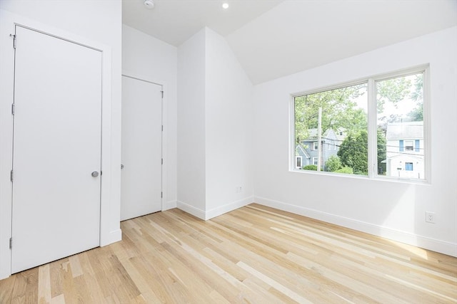 95 Griswold St Unit 95, Cambridge, MA 02139 - unfurnished bedroom featuring lofted ceiling, light wood-style flooring, and baseboards