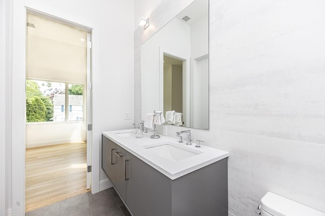 95 Griswold St Unit 95, Cambridge, MA 02139 - bathroom featuring double vanity, toilet, tile patterned floors, and baseboards
