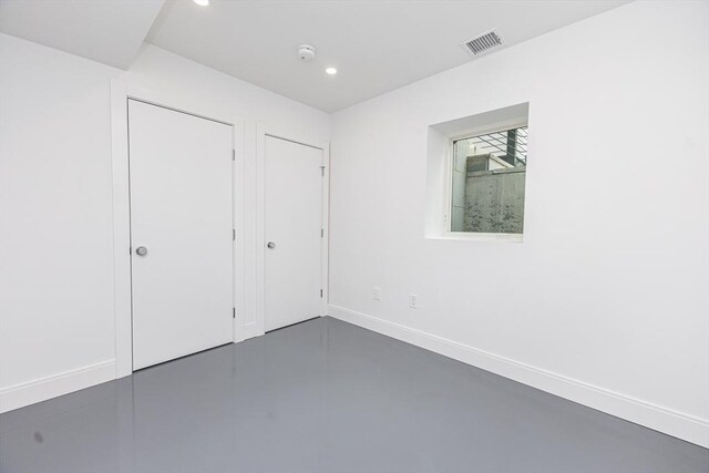 95 Griswold St Unit 95, Cambridge, MA 02139 - unfurnished bedroom featuring finished concrete floors, baseboards, and recessed lighting