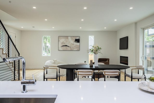 95 Griswold St Unit 95, Cambridge, MA 02139 - dining room featuring light wood-style floors, recessed lighting, stairway, baseboards, and a glass covered fireplace