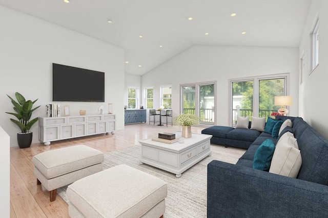 living room featuring light hardwood / wood-style flooring, high vaulted ceiling, and a healthy amount of sunlight