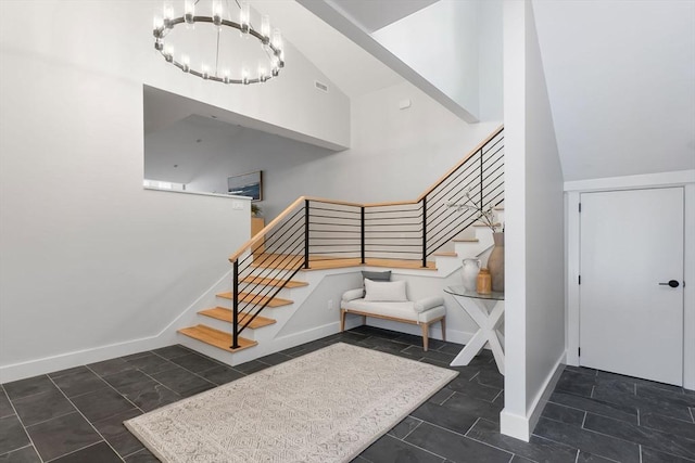 stairs featuring an inviting chandelier, vaulted ceiling, and tile patterned floors