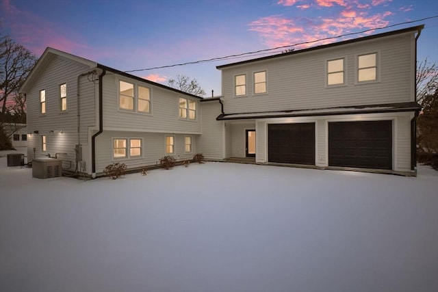 front of property featuring a garage and central air condition unit