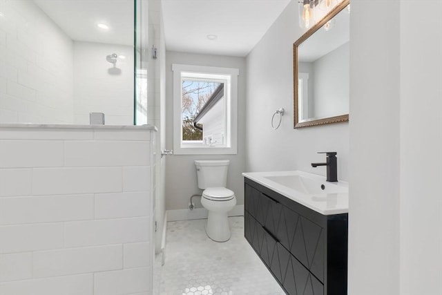 bathroom with vanity, tile patterned flooring, toilet, and walk in shower