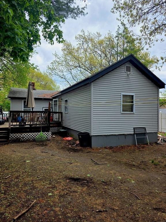 back of house featuring a wooden deck