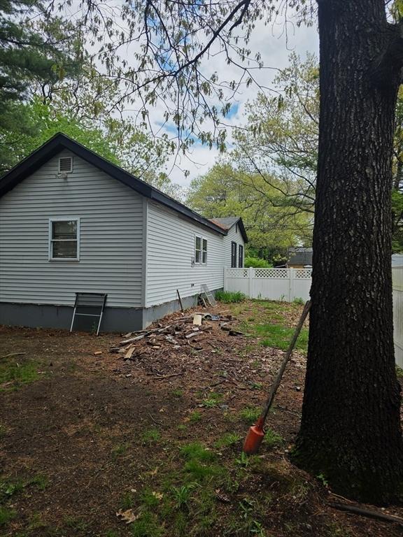 view of side of home featuring fence