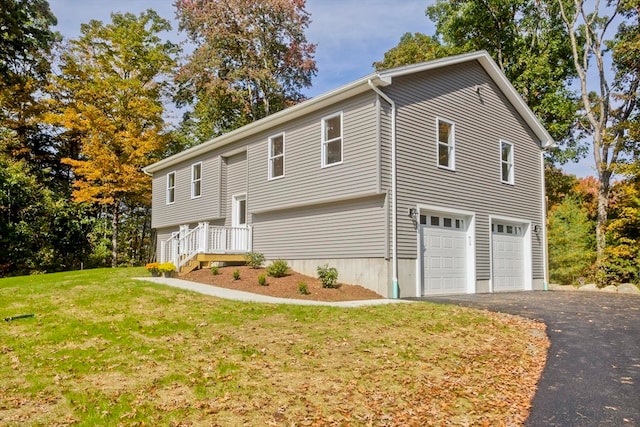 split foyer home featuring a garage and a front lawn