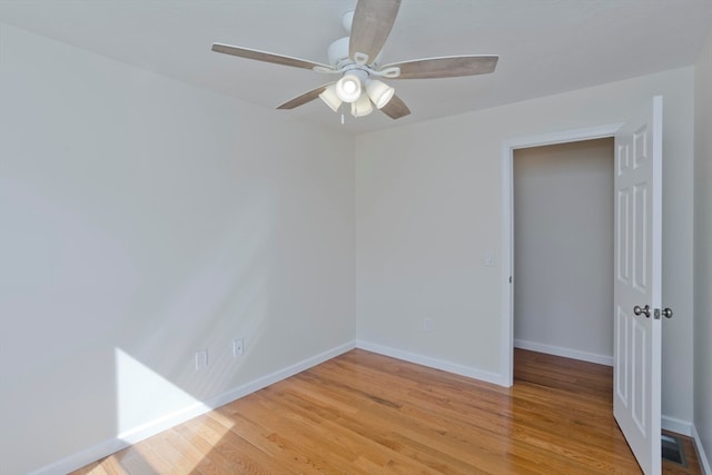 empty room featuring ceiling fan and light wood-type flooring