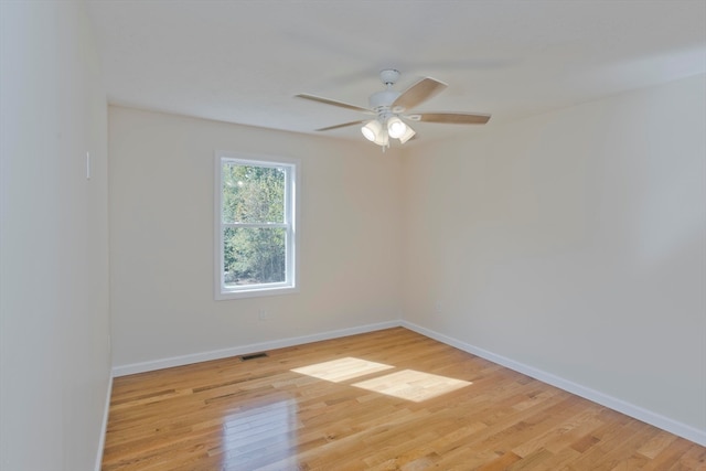 spare room featuring light hardwood / wood-style floors and ceiling fan