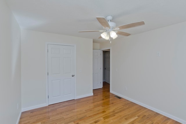 unfurnished bedroom with ceiling fan and light hardwood / wood-style floors