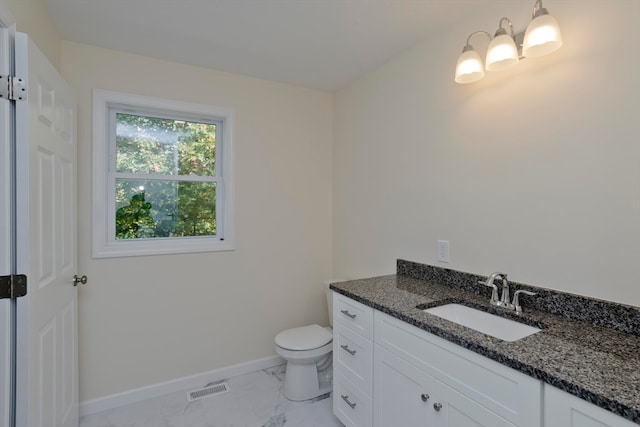 bathroom featuring vanity and toilet