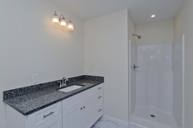 bathroom with vanity and a shower