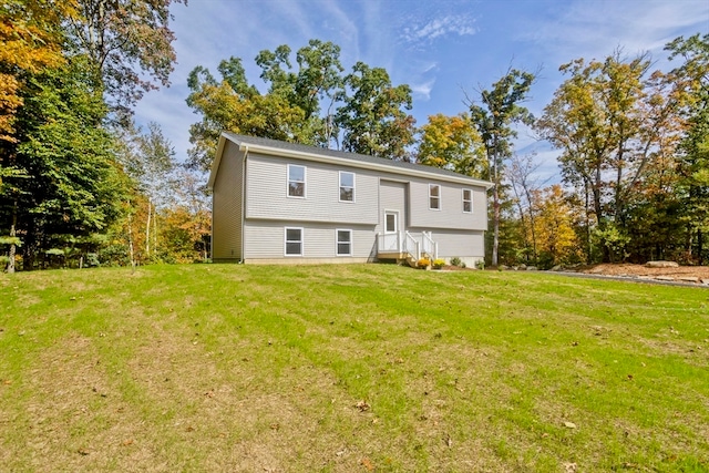 rear view of house with a yard