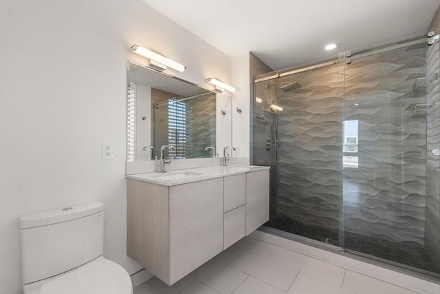full bath with a sink, toilet, double vanity, and a stall shower