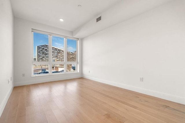 empty room with visible vents, light wood-style flooring, recessed lighting, and baseboards