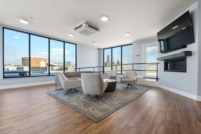 living area featuring light wood-style floors and baseboards