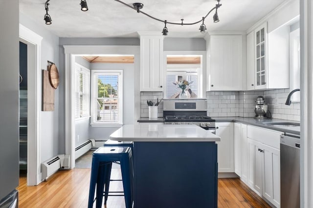 10 Saunders Rd, Lynn, MA 01904 - kitchen with stainless steel appliances, a kitchen island, light wood-type flooring, and white cabinetry