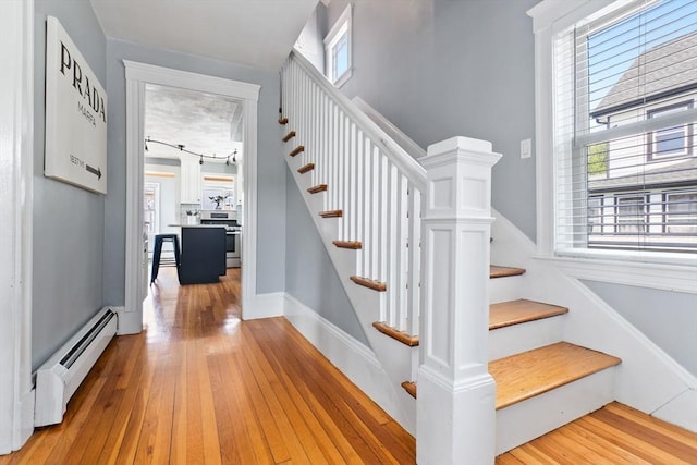 10 Saunders Rd, Lynn, MA 01904 - stairway featuring baseboard heating, plenty of natural light, and wood-type flooring