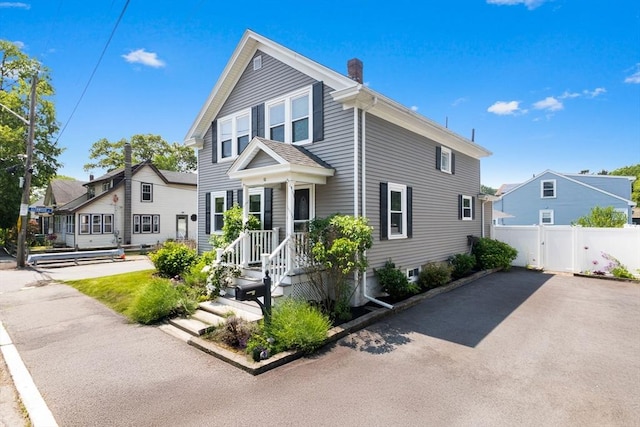 10 Saunders Rd, Lynn, MA 01904 - view of front of home with a chimney, a gate, and asphalt driveway