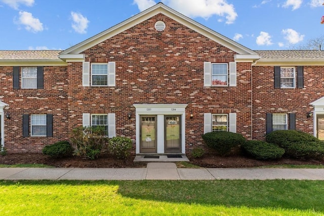 view of property featuring brick siding