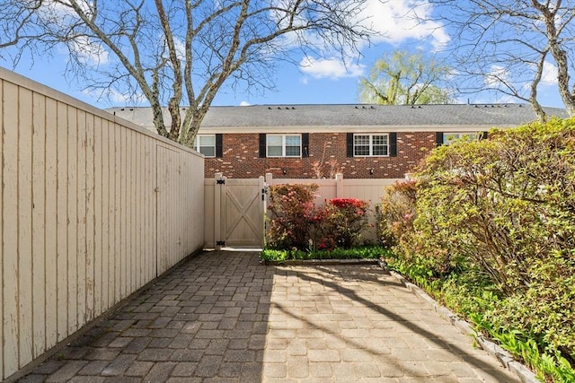 view of patio with a gate and fence