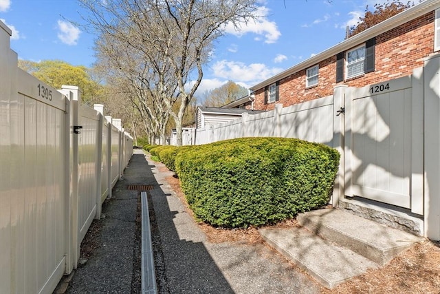 view of yard with fence and a gate
