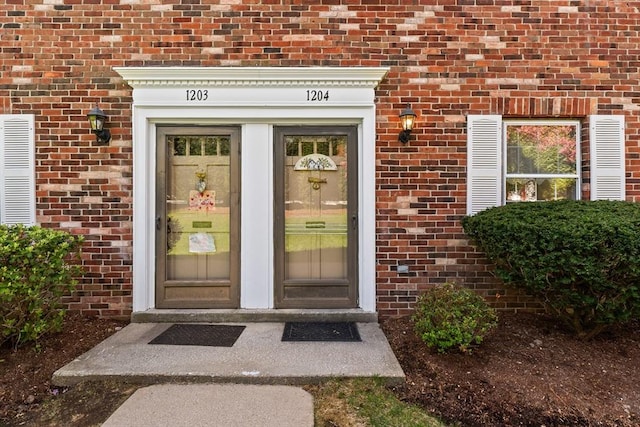 view of exterior entry with brick siding