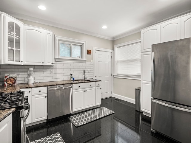 kitchen featuring dark stone counters, white cabinetry, appliances with stainless steel finishes, and dark tile patterned floors