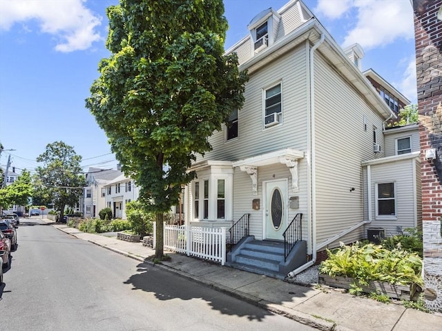 view of front of property featuring fence