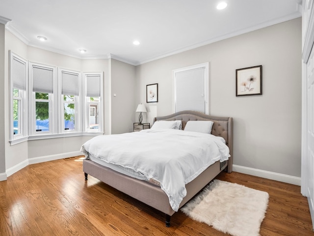 bedroom featuring hardwood / wood-style floors and ornamental molding