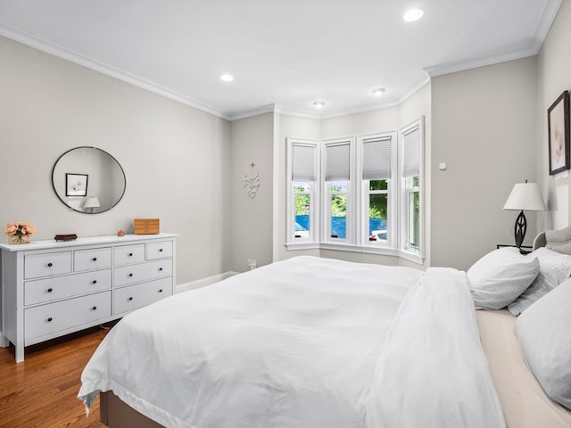 bedroom featuring hardwood / wood-style floors and crown molding