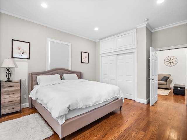 bedroom featuring a closet, crown molding, and wood-type flooring